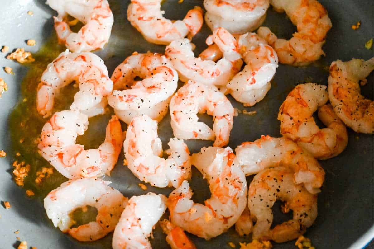 uncooked shrimp in a pan.