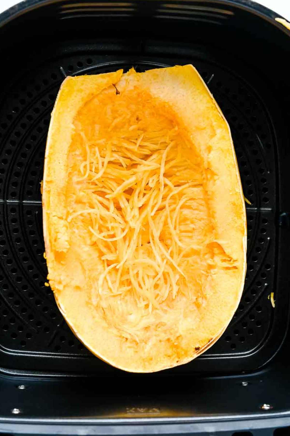 cooked air fryer spaghetti squash in a black basket.