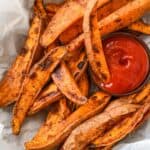 close up shot of air fryer sweet potato wedges with ketchup.