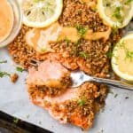 featured image for this almond crusted salmon recipe showing closeup of fish flaking on a fork.