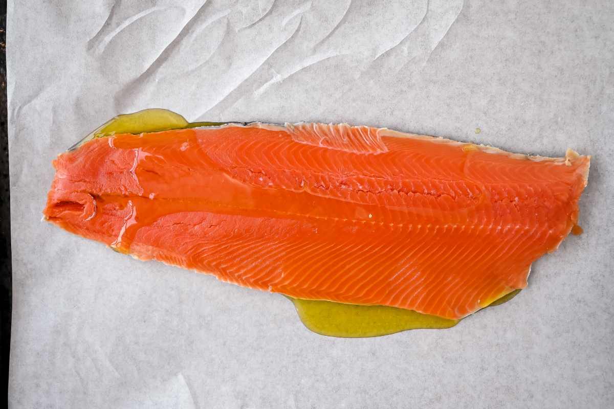 oiled raw salmon on parchment paper.