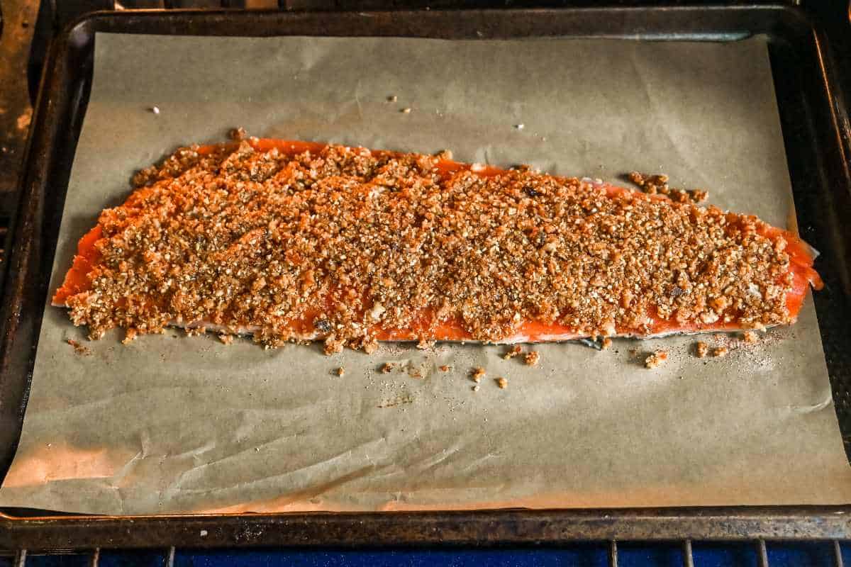 uncooked salmon in the oven on a sheet pan.