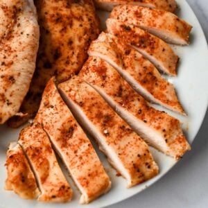 close up of thinly sliced chicken breast cut into pieces.