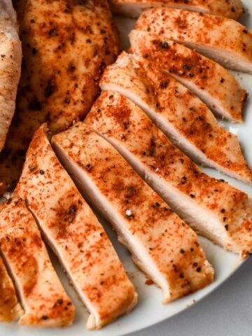 close up of thinly sliced chicken breast cut into pieces.