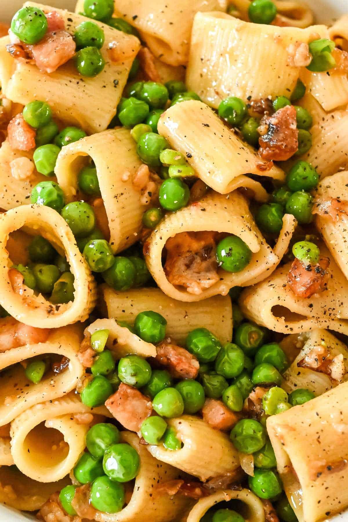 close up of pasta with peas and pancetta.