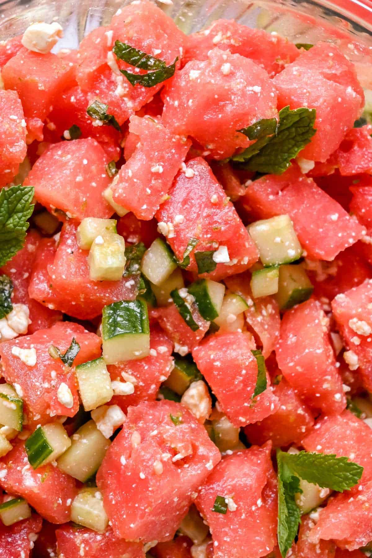close up of watermelon basil salad with cucumbers and feta.