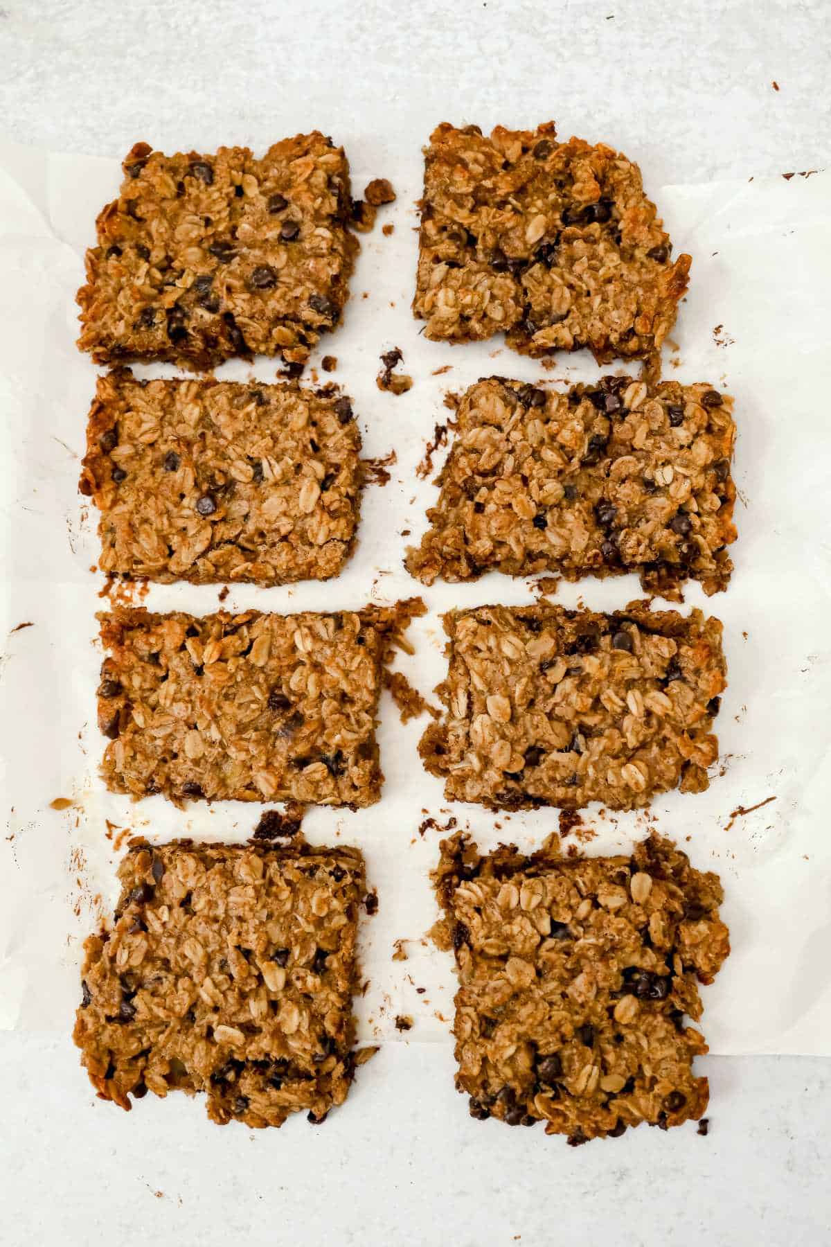 banana oatmeal bars cut on a piece of parchment paper.