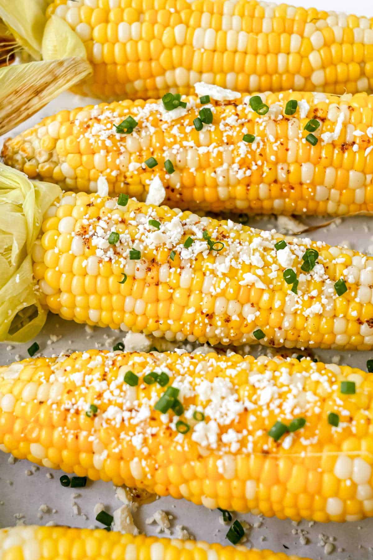 4 ears of pellet grilled corn topped with chili lime butter, cheese, and chives.
