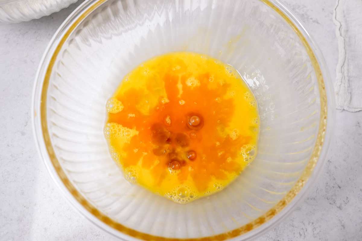 vanilla extract in eggs in a glass bowl