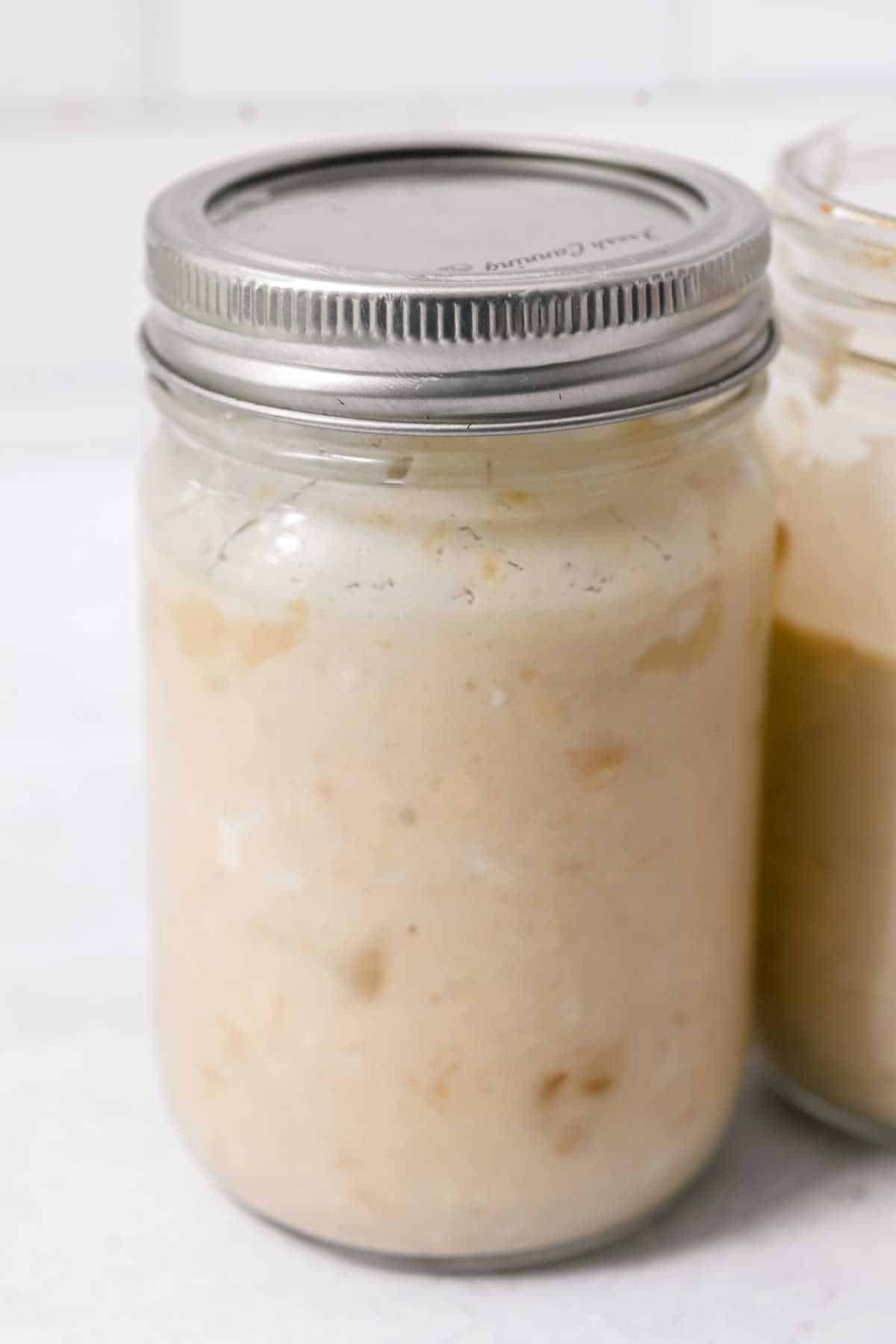 jar of overnight oats with a silver lid.