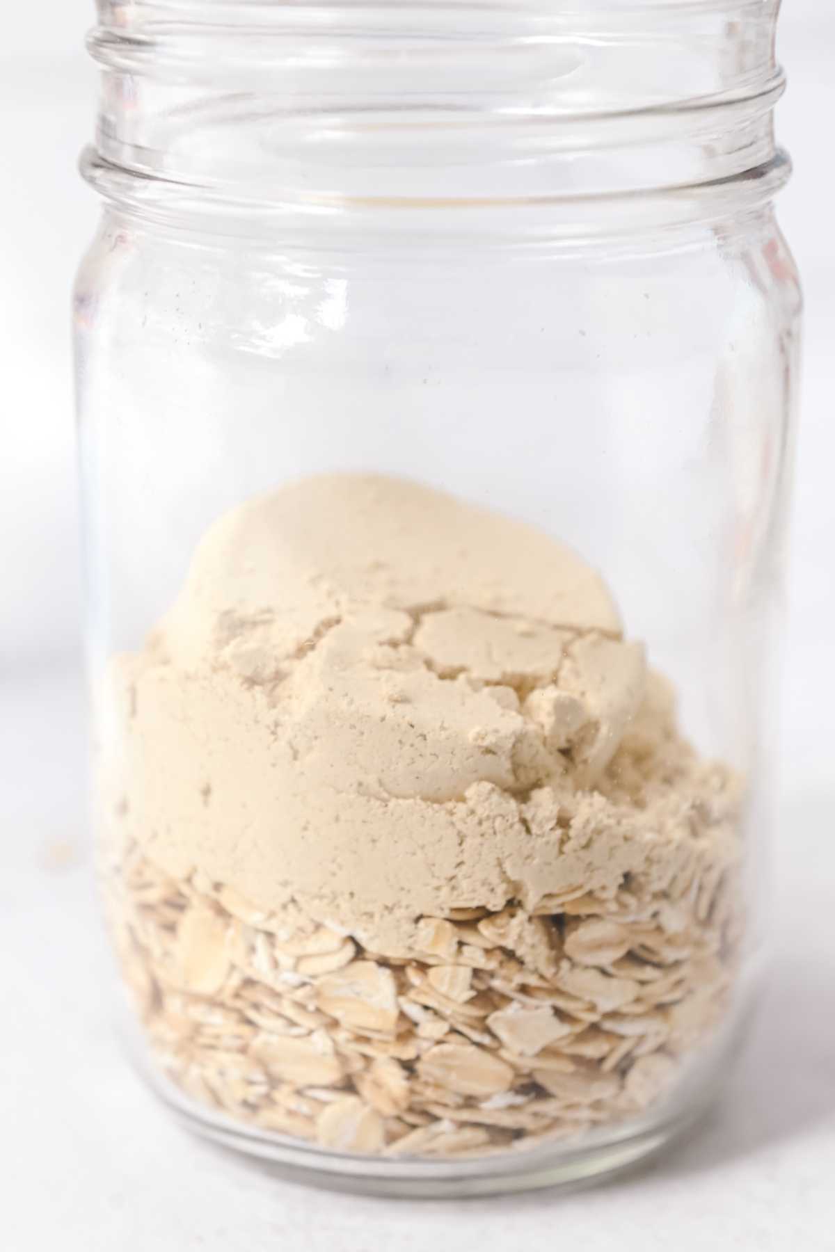 oats and protein powder in a glass jar.