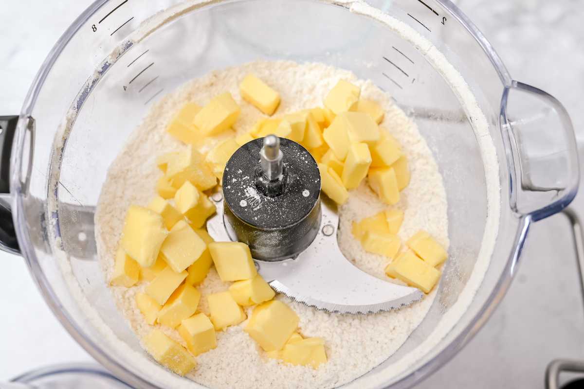 cold butter cubes on top of flour and dry ingredients in a food processor.