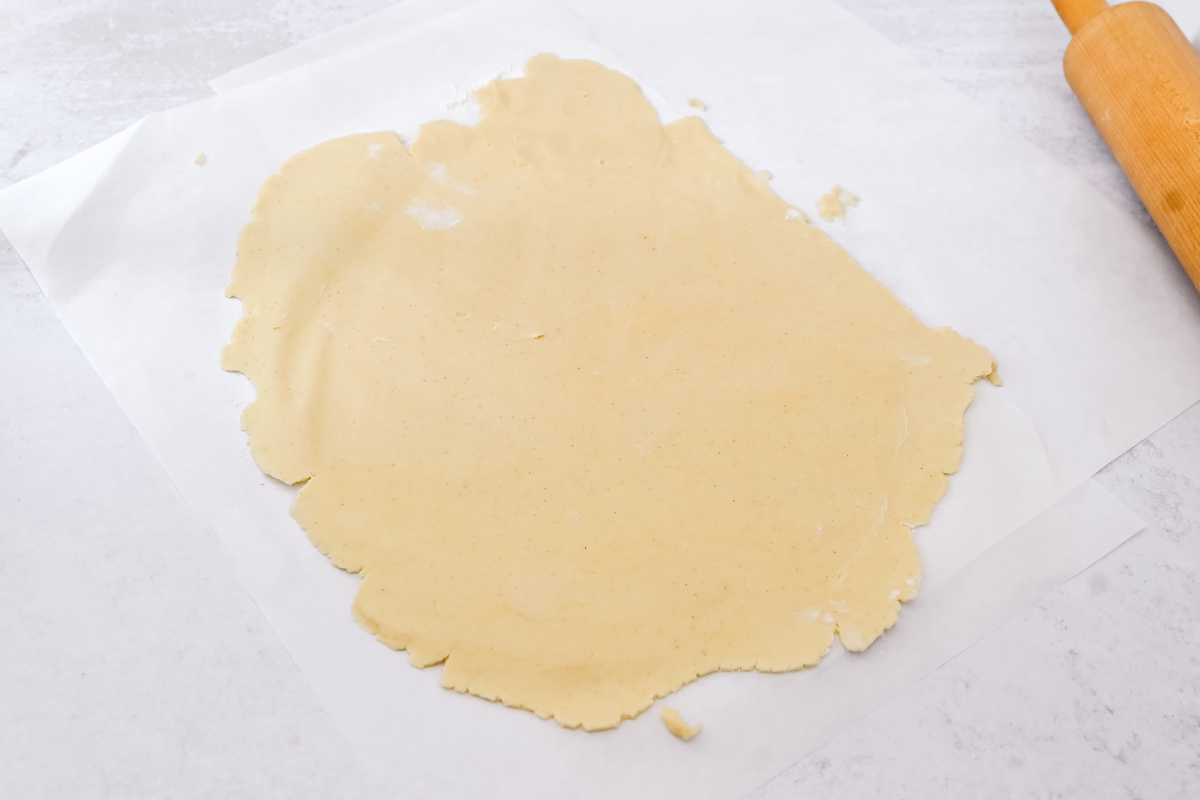 rolled out pie crust on parchment paper.