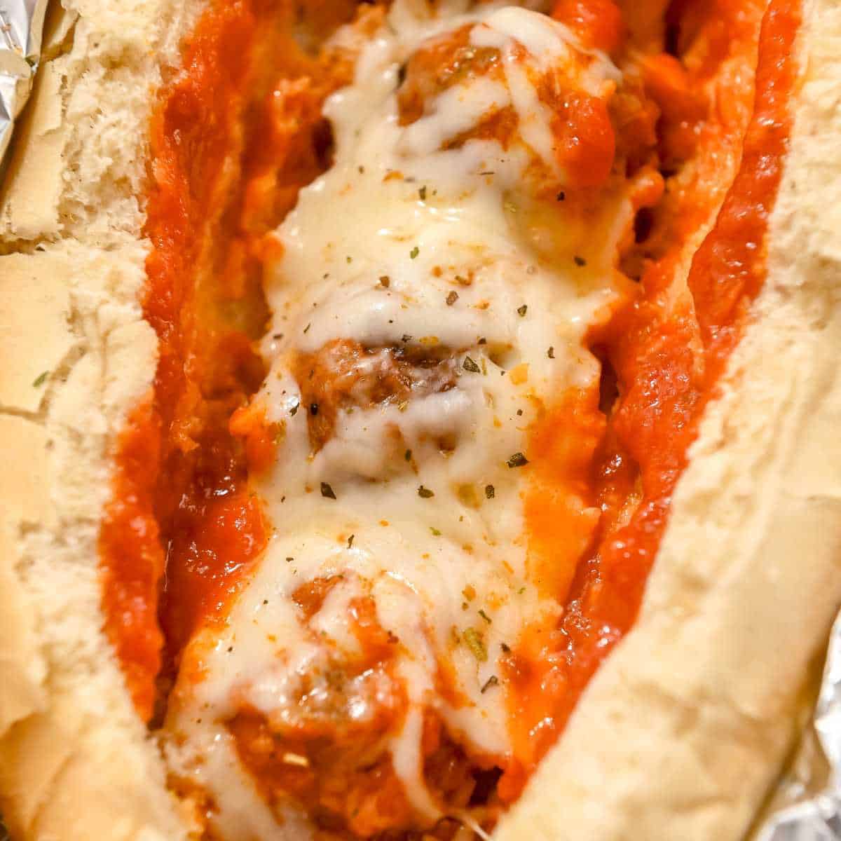 close up of a turkey baked meatball sub topped with melted cheese
