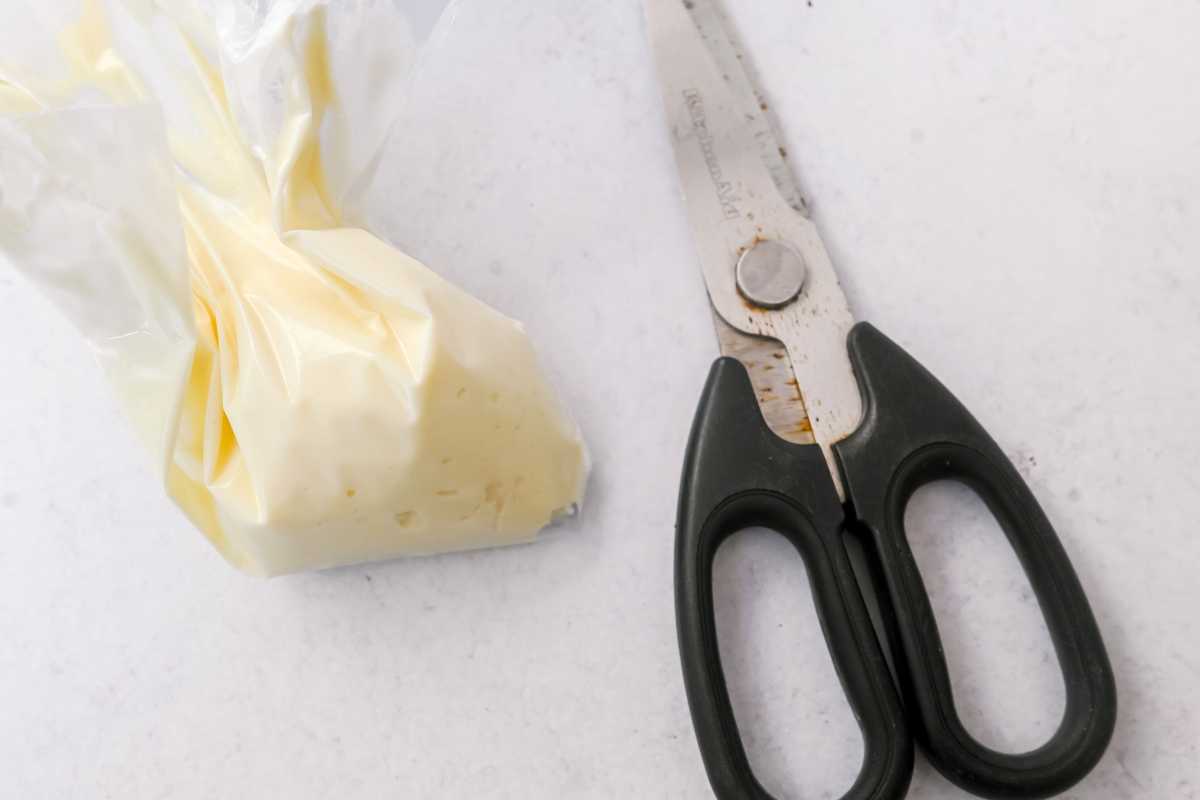 ziploc bag of cream cheese filling next to scissors.
