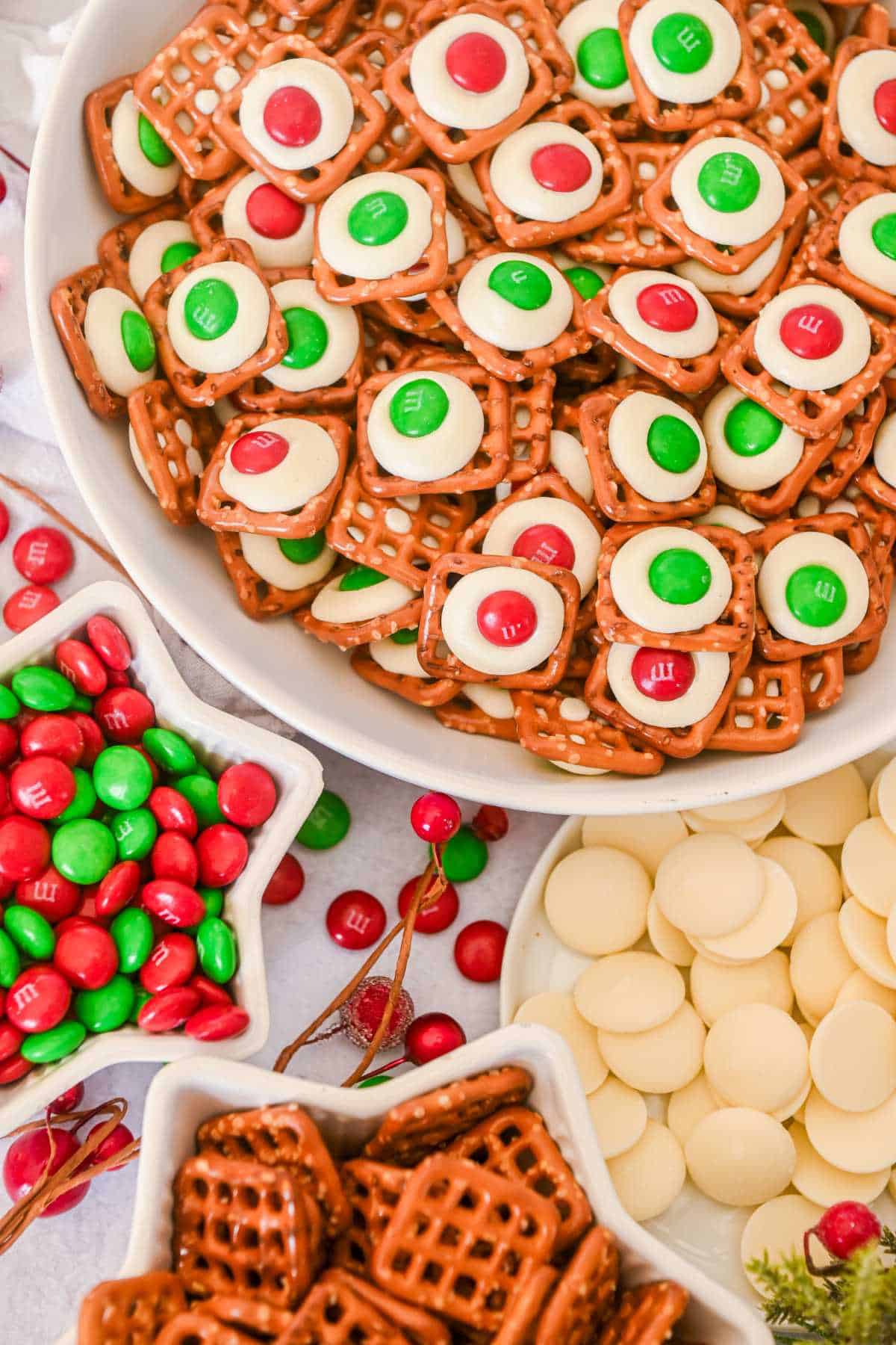 pretzel white chocolate m&m snaps in a bowl next to ingredients in bowls.