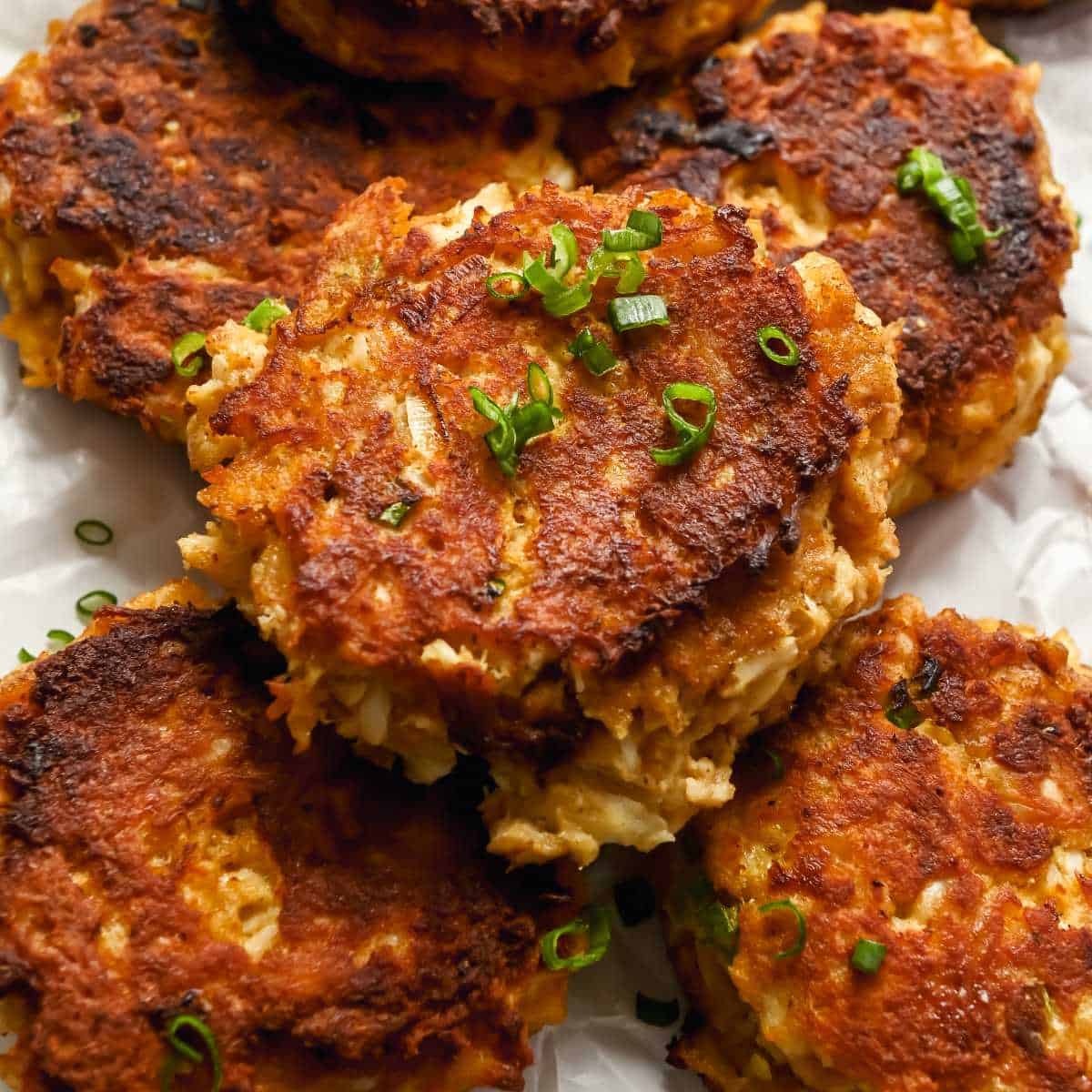 close up of Maryland-style crab cakes topped with green onions.