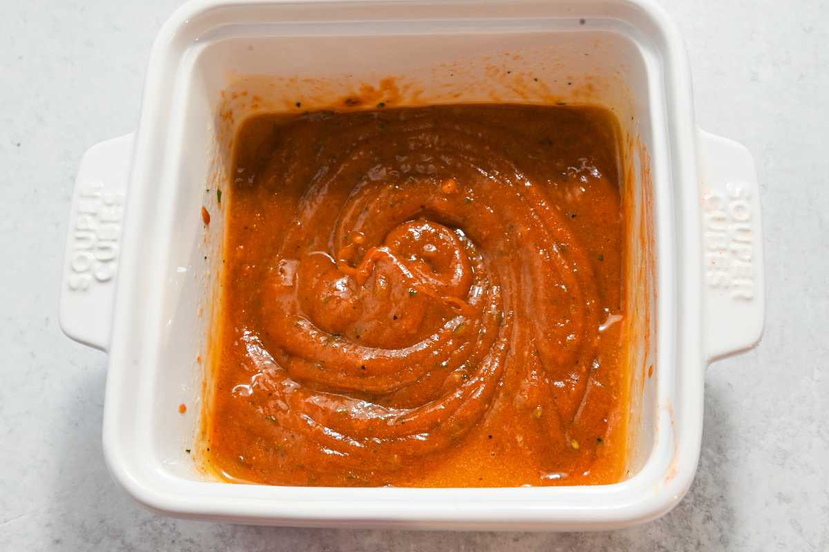 buffalo wing sauce in a white square bowl.