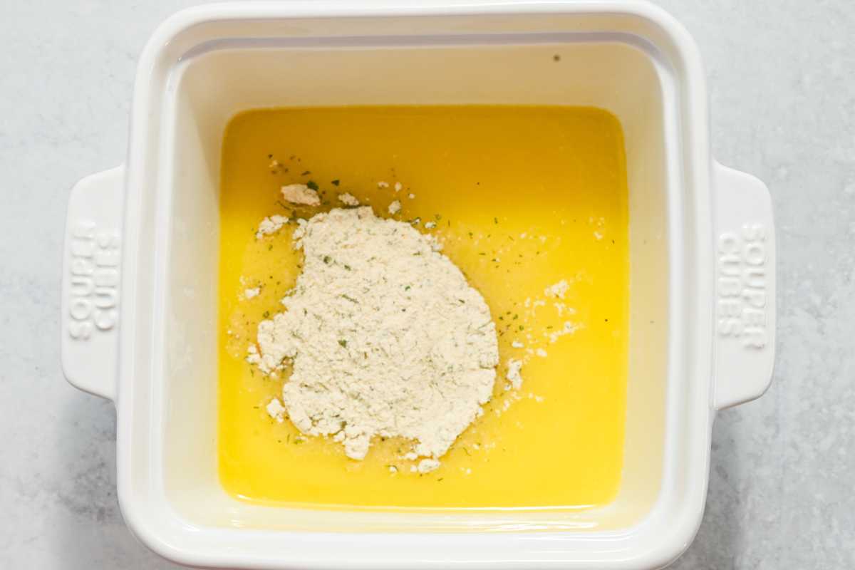 melted butter with ranch seasoning in a white square dish.