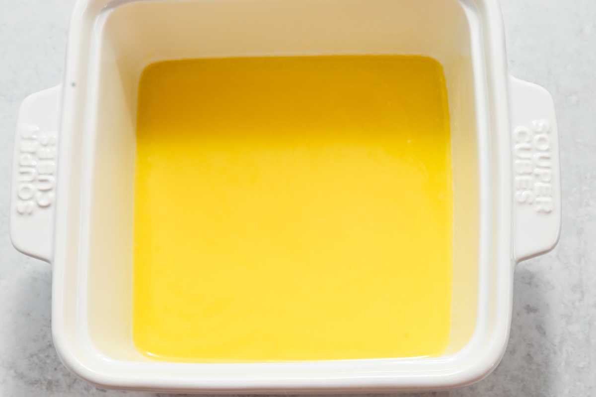 melted butter in a white square dish.