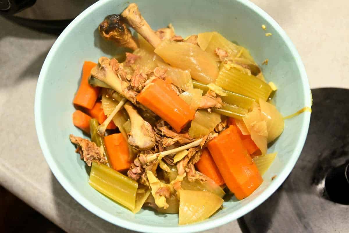 excess scraps in a green bowl from making bone broth in an instant pot.