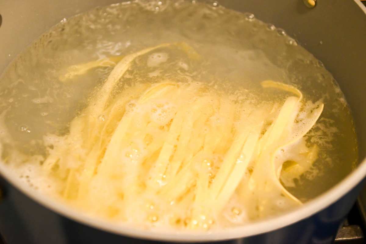 cooking fettuccine in pasta water.