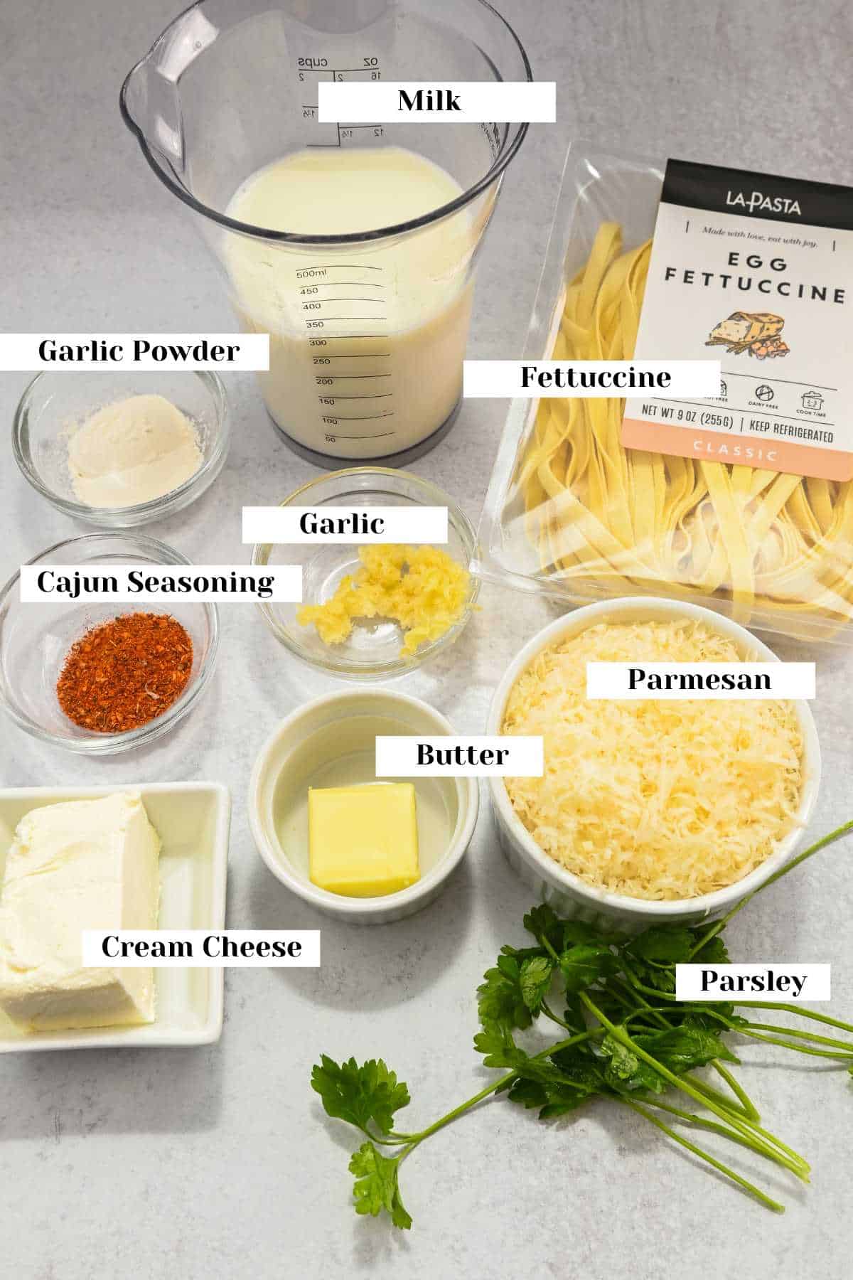 labeled ingredients for making cajun pasta alfredo.